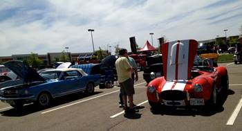 A person standing next to a car that has its hood open

Description automatically generated with low confidence